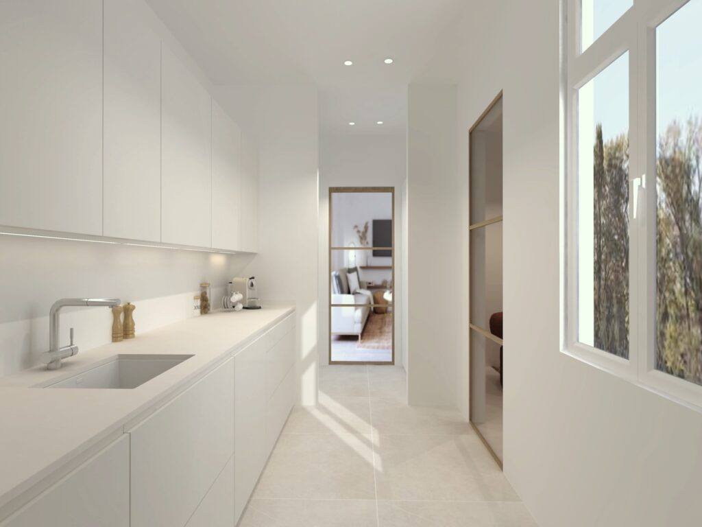 Esta cocina en forma de L ha sido proyectada con una clara apuesta por el equilibrio entre funcionalidad, luz natural y estética contemporánea.